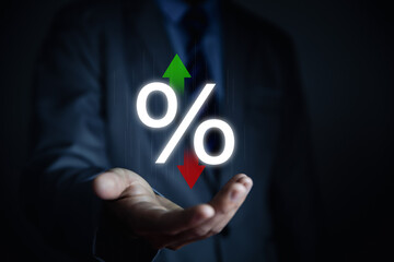 Businessman hand showing percentage icon and up or down arrow, interest rate increases