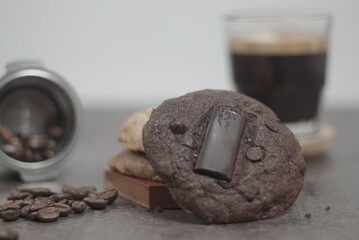 Cookies with topping chocolate bar with a cup of black coffee