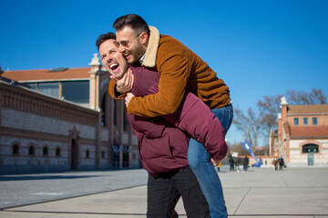 A portrait of happy gay couple outdoors 
