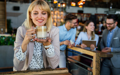 Group of happy multiethnic successful business people having fun, work and meeting in cafe.