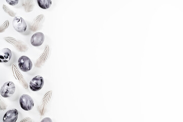 Eggs painted marble on white background. Minimal Easter concept with space for text. Black monochrome luxury backdrop.