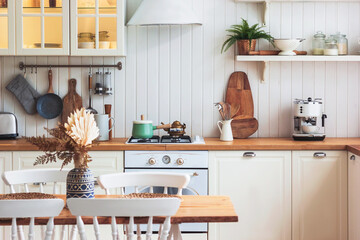Kitchen wooden table and kitchen background. Interior style is cosy and scandinavian. High quality interior scandi photo. 