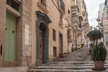 Fototapeta na wymiar Stunning stairs in a narrow street on a hill in valletta