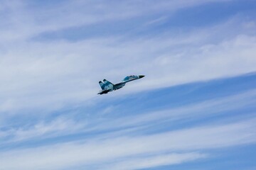 MAKS-2011 on territory of airfield LII im. Gromov. Russian multipurpose fighter Su-27 (NATO - Flanker-C) of Russian Knights aerobatic team performs climb flight. Zhukovsky, Russia - August 19, 2011