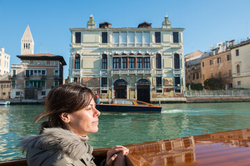 Fototapeta na wymiar Woman Travel on Taxi Boat in a Sunny Day in Venice, Veneto in Italy.