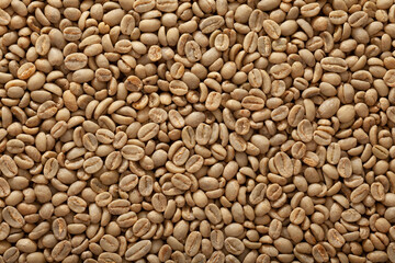 Top view macro photography shot of a bucket full of green raw un-roasted coffee beans