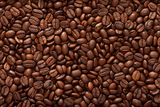 Top view macro photography shot of a bucket full of roasted coffee beans