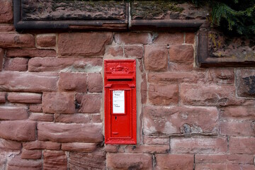 Traditional red mail letter box in a stone wall.
King George (G stands for George, R stands for Rex, which is King in Latin). 