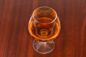 Brandy in cognac glass on a wooden table