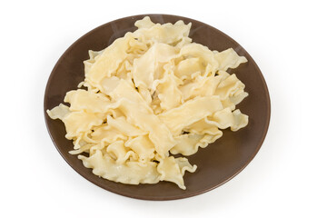 Boiled short noodles on brown dish on a white background