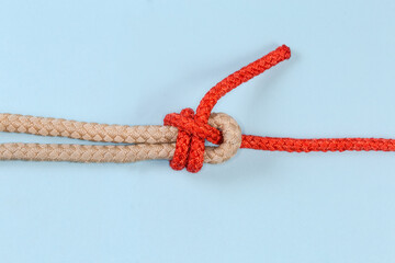 Rope knot Duble sheet bend on blue background close-up