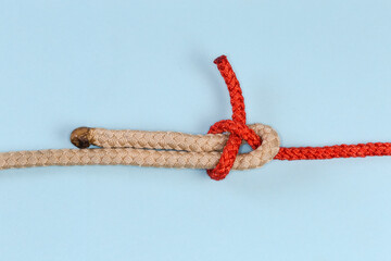 Rope knot Sheet bend on a blue background close-up