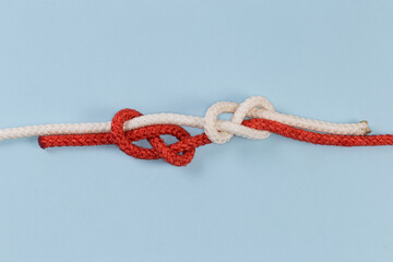 Untightened rope sliding figures of eight knot on blue background