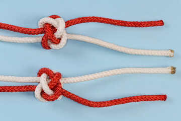 Tightened rope Diamond knot, two-sided view on blue background