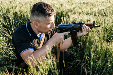 The man in the field with a machine gun, Ukrainian men prepare for the war.