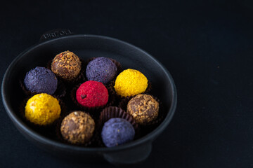 Sweets multi-colored round on a dark concrete background