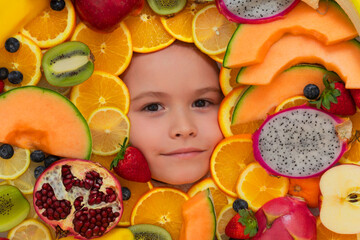 Top view of cute kids face with different fruits. Summer fruits. Kids face with mix of fruits. Assorted fruits.
