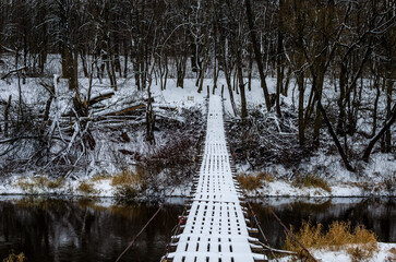 Suspension bridge on a cloudy winter day