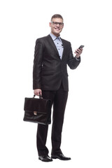 in full growth. responsible young businessman with a smartphone.