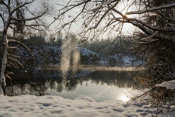  Icy falling from trees at an old flooded quarry. Opatovice. Central Moravia. Czechia.