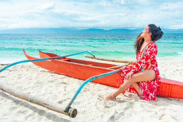 Transgender woman posing in colorful swimwear,on a boat,White Beach,Moalboal,Cebu Island,Philippines.