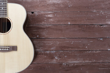 Musical instrument - Silhouette of a spruce top left handed acoustic guitar on wooden