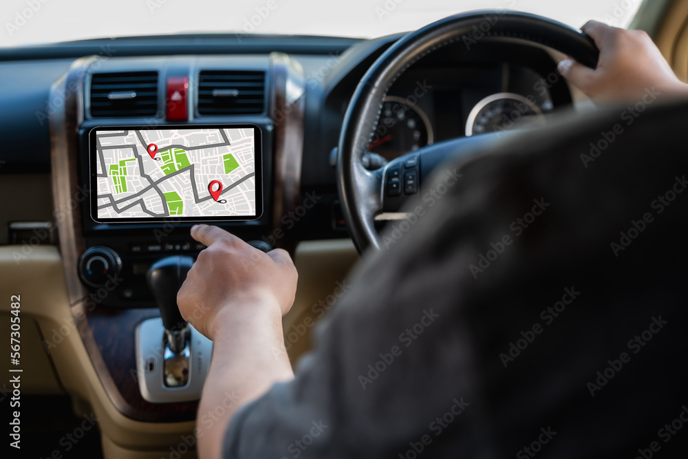Poster a man makes use of gps and the internet. online map in the car controls the navigator for gps tracki