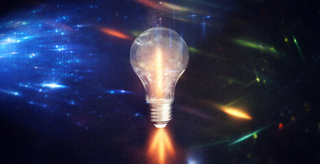 Light bulb over dark black background. Concept of creativity and innovation