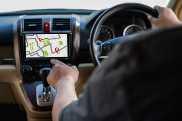 A man makes use of GPS and the internet. online map in the car controls the navigator for GPS tracking.