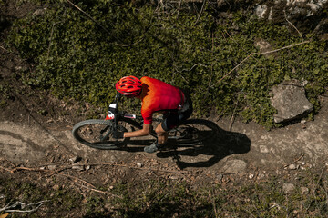 top view male athlete on mountain bike biking on trail