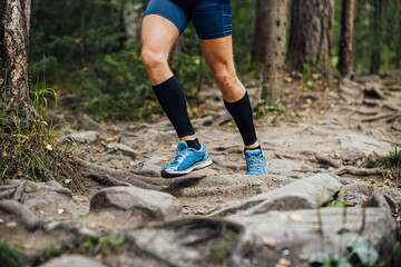 Fototapeta na wymiar legs runner in compression calf sleeve running trail