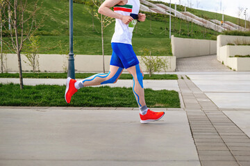 athlete runner on legs kinesio taping running marathon