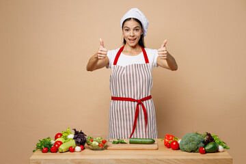 Young housewife housekeeper chef cook latin woman wear apron toque chefs hat work at table...