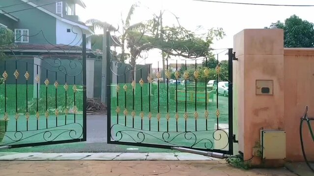 Time lapse video of a badly spoiled and damaged electric automatic gate going haywire moving and swinging on its own