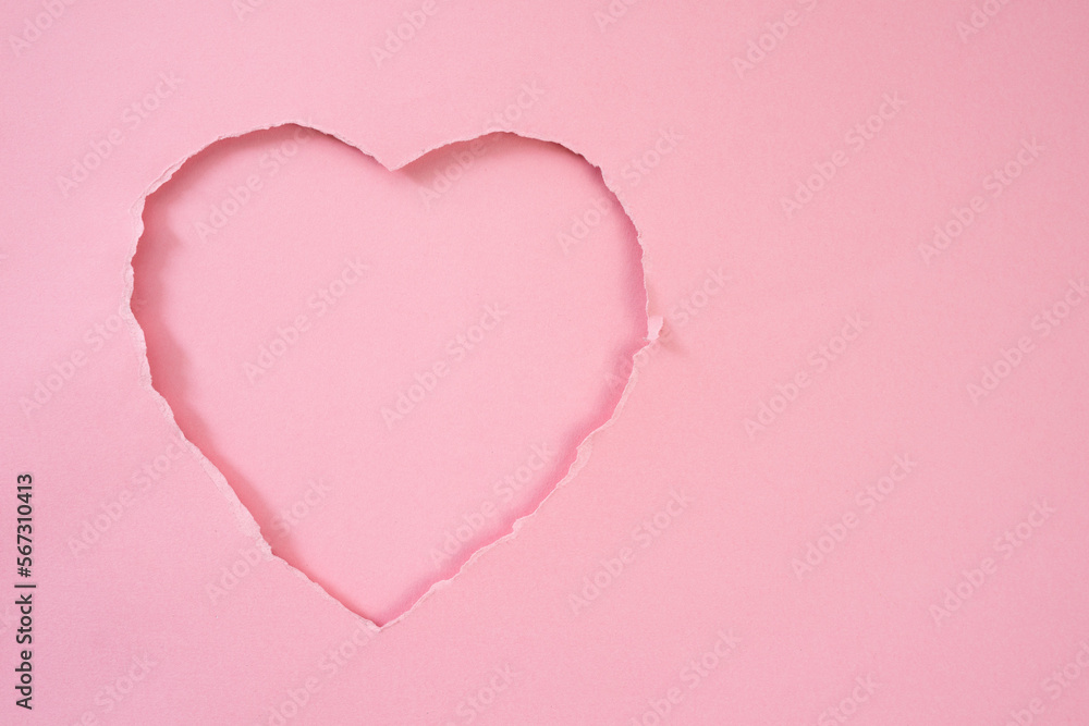 Poster pink torn paper in heart shape for background and copy space