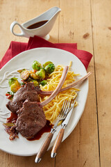 Delicious deer steaks with spaghetti