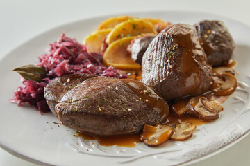 Meat with mushroom sauce on plate