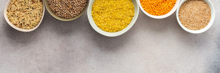 Various grain cereals in bowls banner, top view