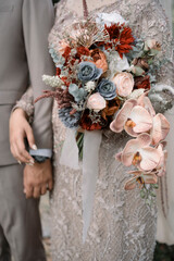 a beautiful bouquet of flowers held by the wedding couple