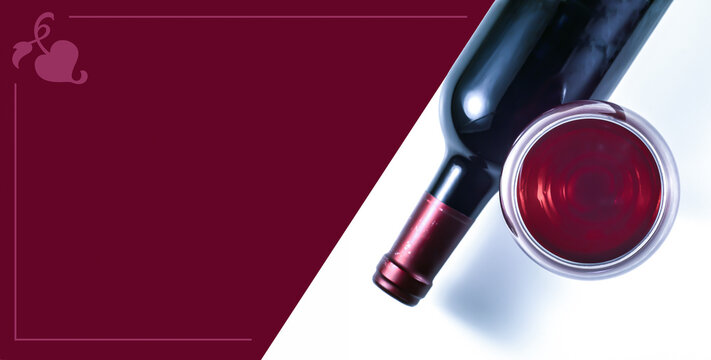 Glass and bottle of red wine on a white background. Red background for text material about wine.