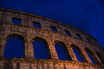 Fototapeta premium Pula Arena in Istria during Evening. Beautiful Roman Amphitheater with Night Sky in Croatia.