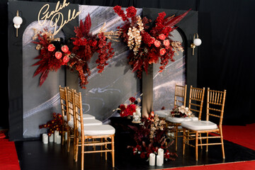 decorating the wedding ceremony with an elegant red and black theme