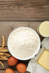 Ingredients for baking or cooking, egg flour, rolling pin butter, milk on a grey wooden background Cookie pie or cake recipe.