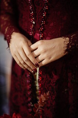 Close up of the elegant maroon bride's dress