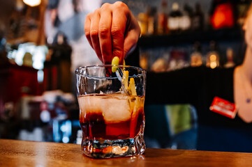 woman hand bartender making negroni cocktail