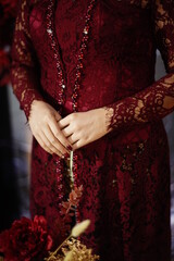 Close up of the elegant maroon bride's dress