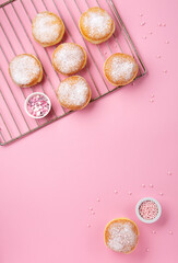 Donuts Doughnuts with Icing Sugar and Sprinkles on Pink Background