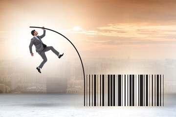 Businessman jumping over bar code in pole vaulting