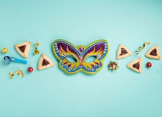 Hamantaschen Cookies, Carnival Mask, Noisemaker on Mint Green Background. Purim Celebration, Jewish...