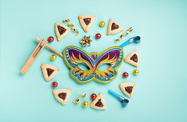Hamantaschen Cookies, Carnival Mask, Noisemaker on Mint Green Background. Purim Celebration, Jewish...